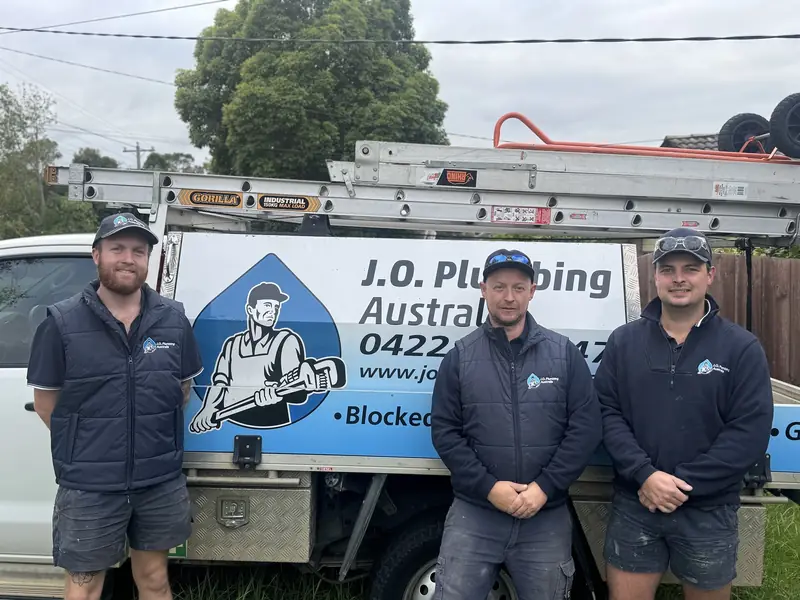 J.O. Plumbing Australia team standing in front of branded work van in Melbourne